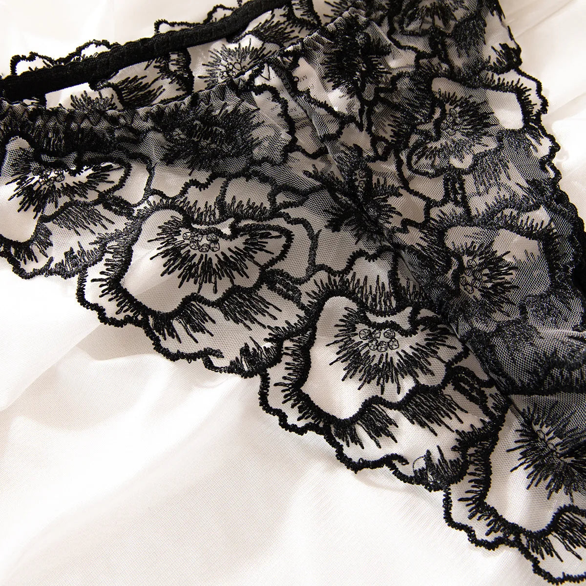 Black women's lace embroidered bikini set with steel rings and sheer construction