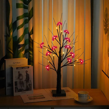 60cm tall white LED birch tree night light on a table, available in black, pumpkin, bat, or maple designs.