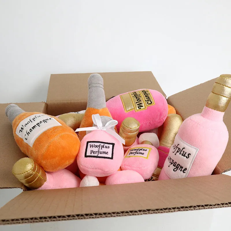 Soft green plush wine bottle pet toy for cats and dogs on a white background.