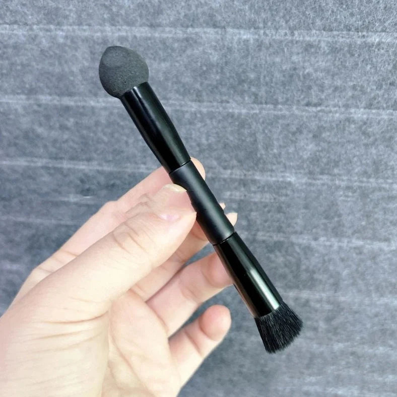 Black sponge stick concealer brush with wooden handle and tapered tip for dark circle coverage