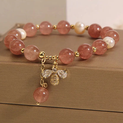 Women's adjustable bracelet with freshwater pearls, strawberry quartz stones, and bee charm