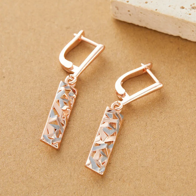 A pair of rectangular hollow stud earrings with a two-tone electroplated finish.