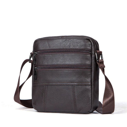 Vertical vintage brown leather shoulder bag for men showing front zipper and soft handle.