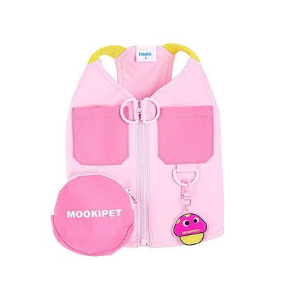 Pink polyester dog vest harness on a small white dog, showing back traction loop and casual fit.