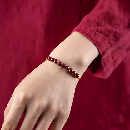Hand-woven cinnabar bracelet with Hetian jade accents and simple geometric design