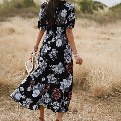 Floral summer beach dress with V-neck, elastic waist, and large hemline in mid-length design