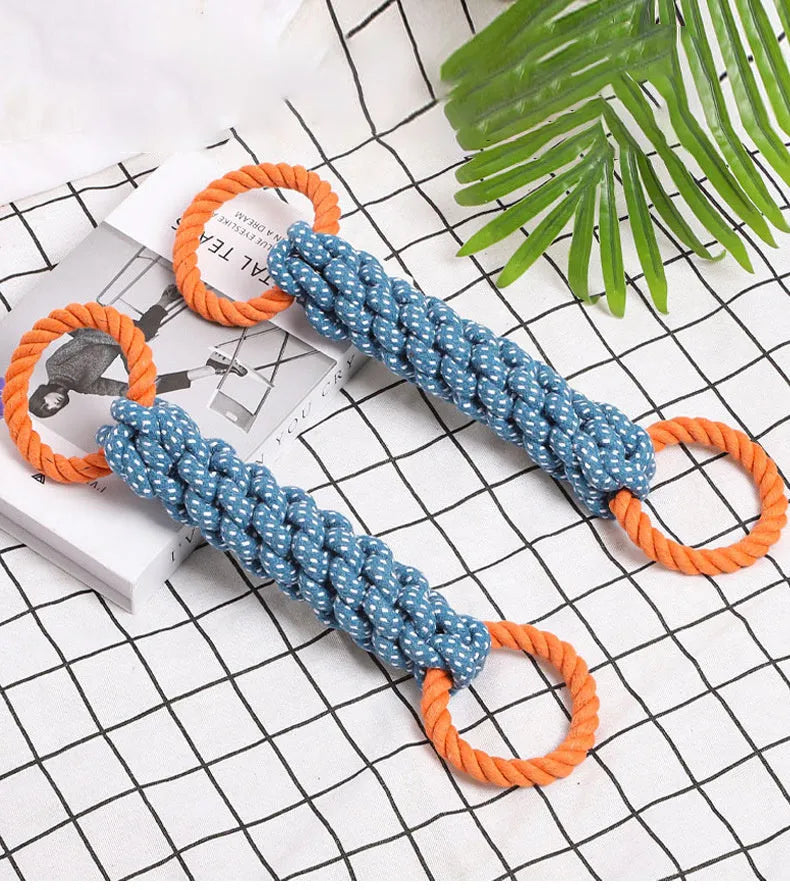 Blue braided bone-shaped cotton rope dog toy with two end rings on a white background.