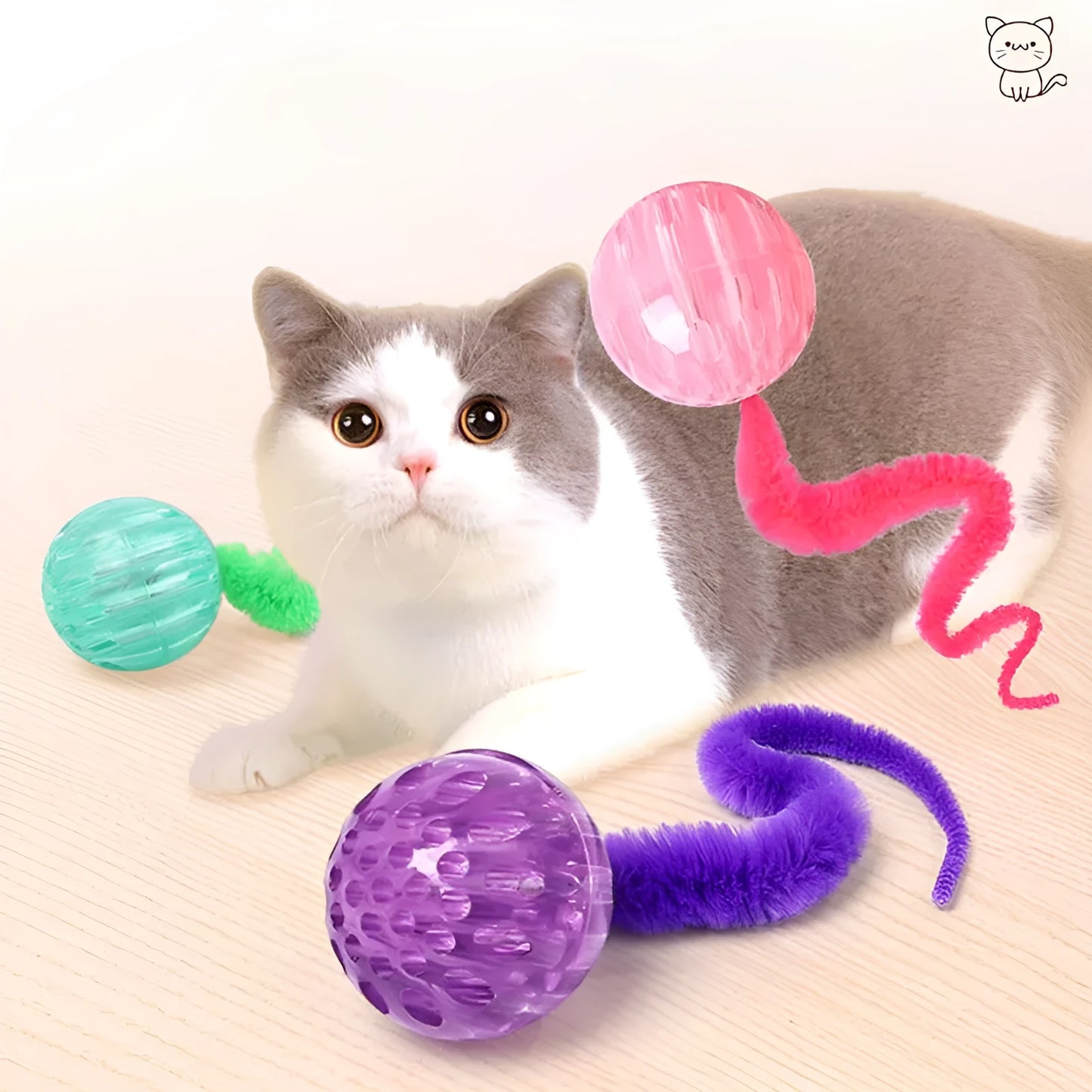Green interactive cat toy with a bouncy ball and a long worm-shaped tail on a plain background.