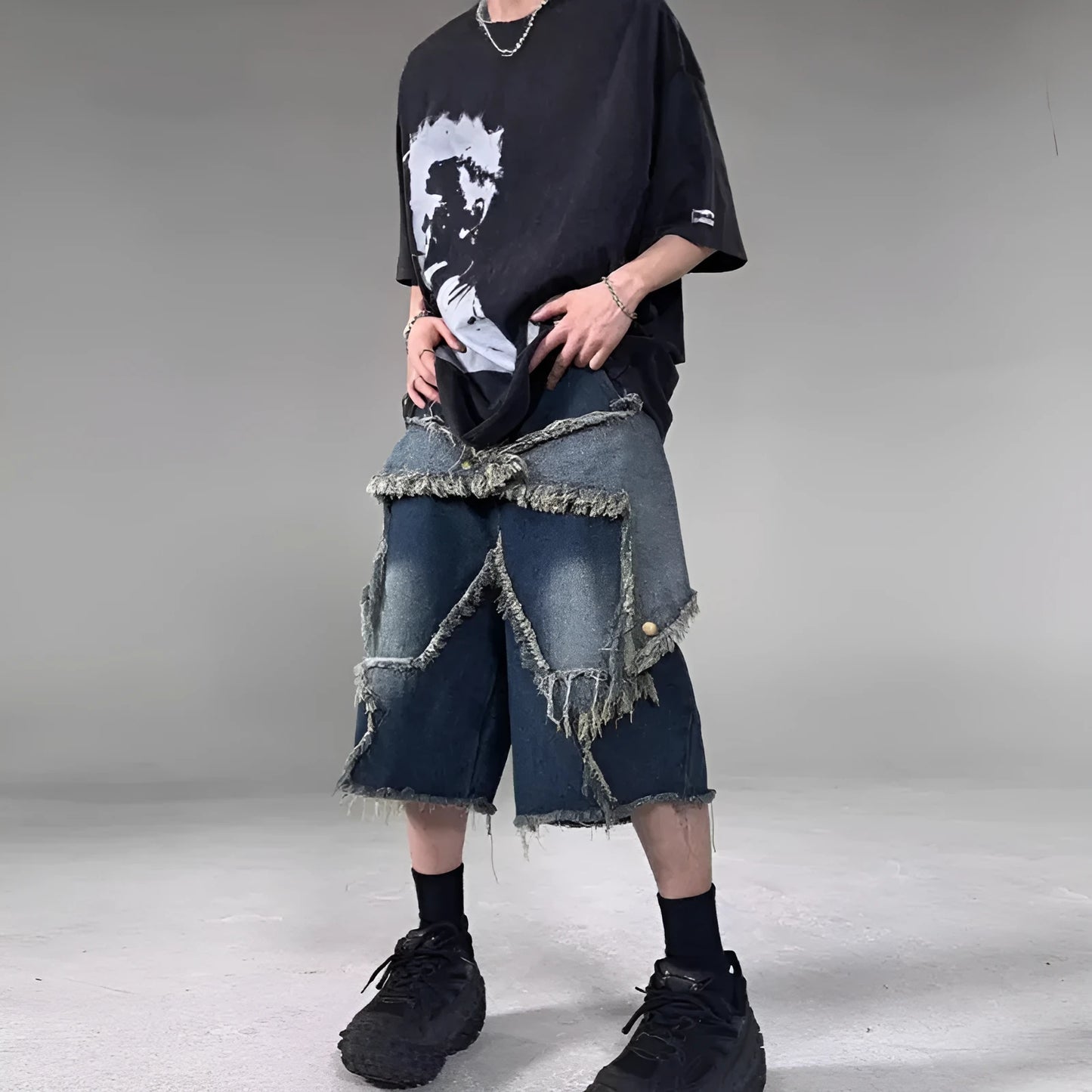 Blue men's denim shorts with frayed hem, loose fit, and a white five-pointed star patch on the leg.