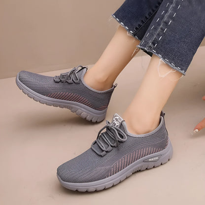 Women's black breathable mesh sneakers with round toe and cross strap lace-up detail