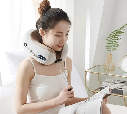 Brown U shaped electric neck massage pillow on a grey background