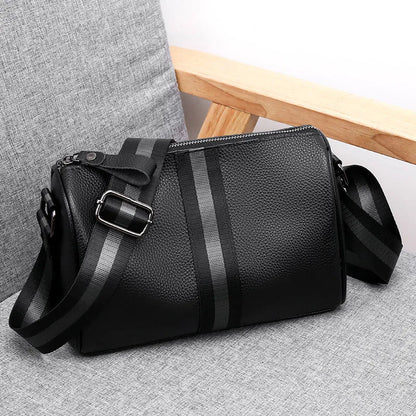 Black genuine leather one-shoulder crossbody bag with large main compartment and polyester lining.