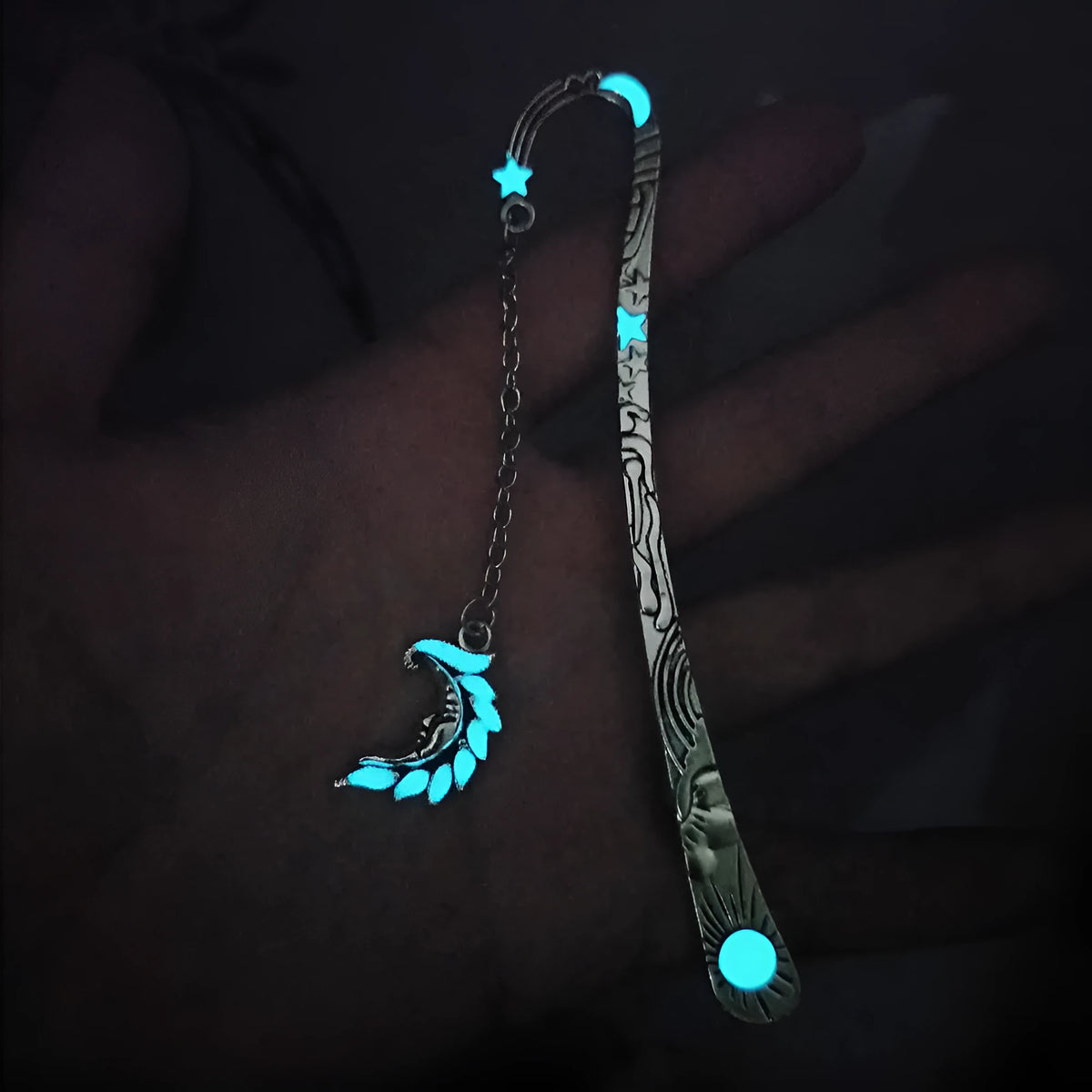 Retro five-pointed star glowing metal bookmark in ancient silver and bronze finishes on an open book.