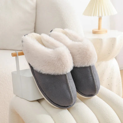 Women's plush winter slippers with round toe, flat heel, and stitching detail on a non-slip PVC sole.