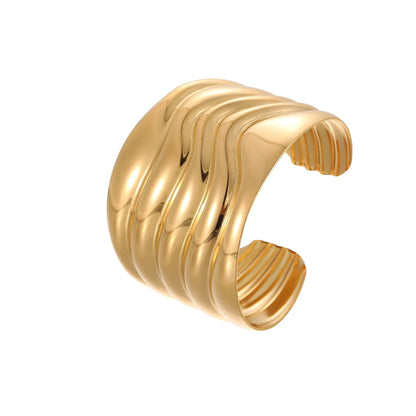 Women's stainless steel bracelet with 18K gold plating featuring exaggerated wide geometric wave design and niche opening