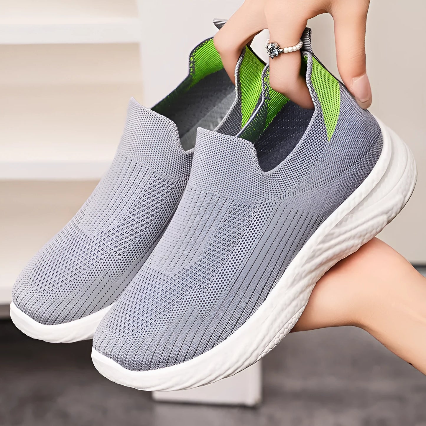 Women's Flyknit casual running shoes with soft PVC sole in black, grey, pink, and blue colour options.
