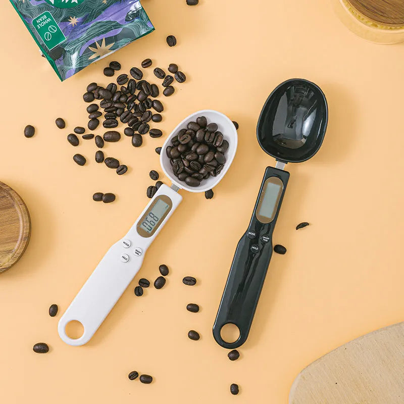 White digital spoon kitchen scale with LCD display showing weight measurement