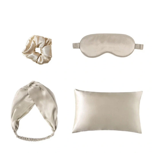 Luxury silk sleep set with eye mask, pillowcase, and hair accessories in champagne colour