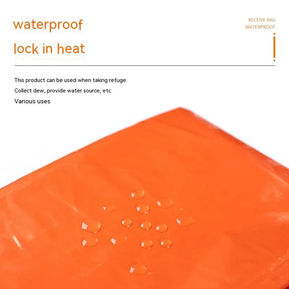 Orange emergency tent with sleeping bag and blanket disaster relief kit on ground