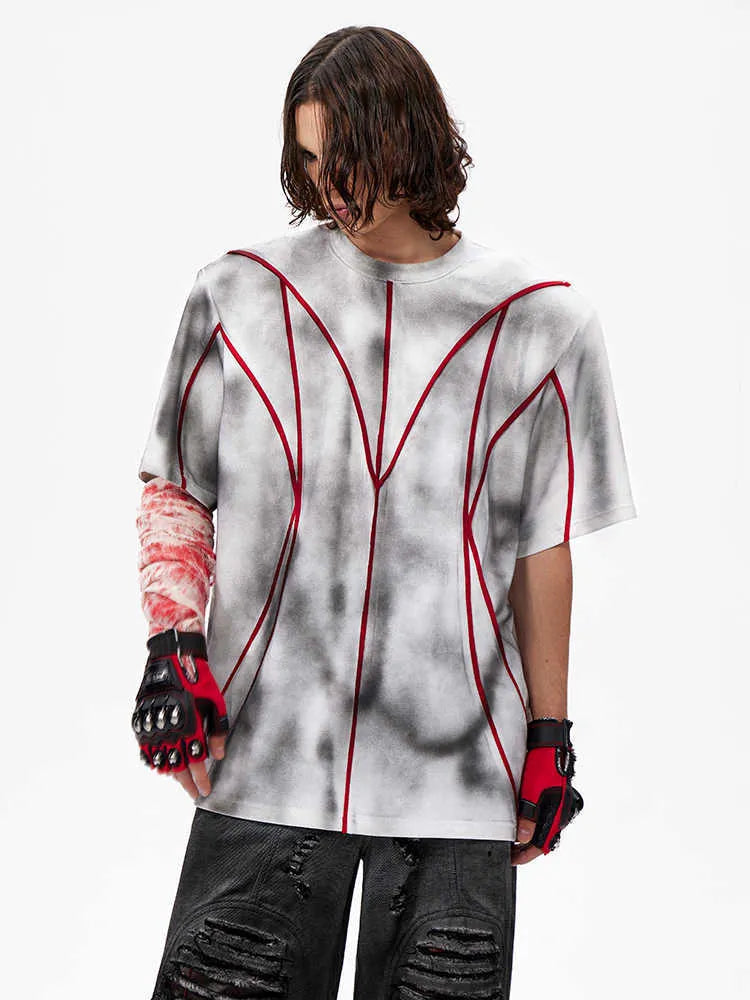 Padded shoulder short sleeve T-shirt with three-dimensional line patchwork detail on a mannequin.