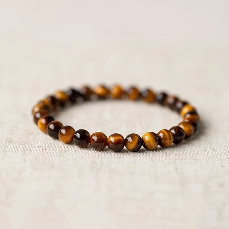Tigereye dzi bead buddha bracelet with adjustable closure, shown in simple bracelet style.