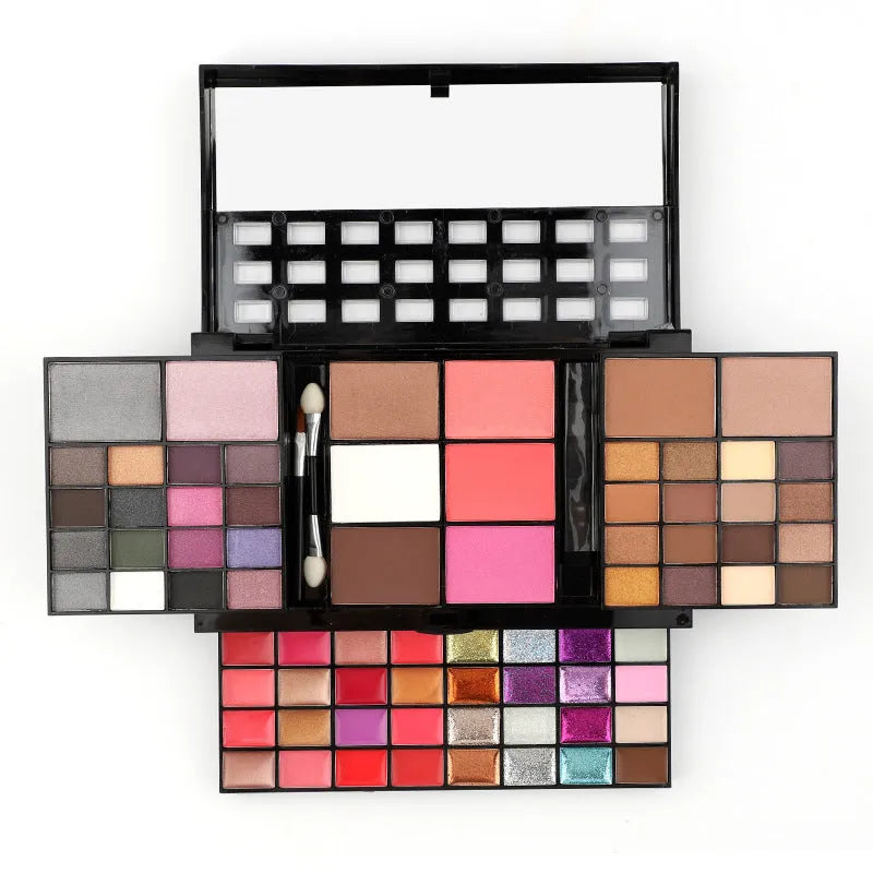 Open 74 colour makeup combination palette showing four layers of eyeshadow, lip gloss, blush and contour powders with brushes.