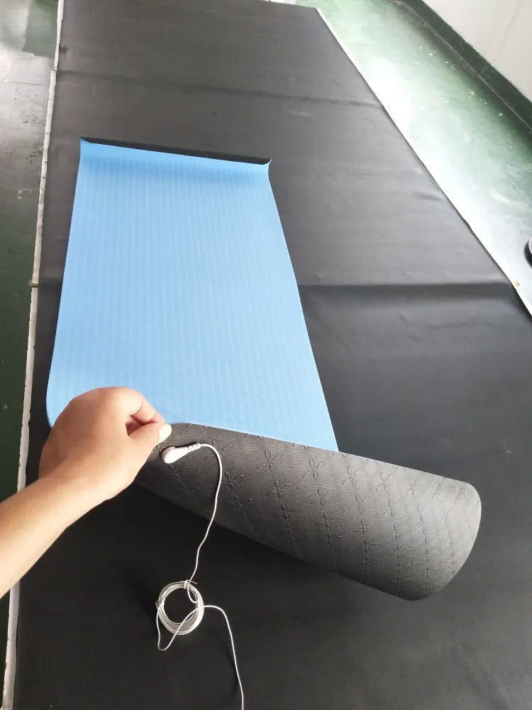 Blue conductive yoga mat with plants pattern, grounding wire, and dimensions 182cm by 61cm.