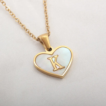 Gold-plated heart necklace with white shell pendant showing letter personalisation option