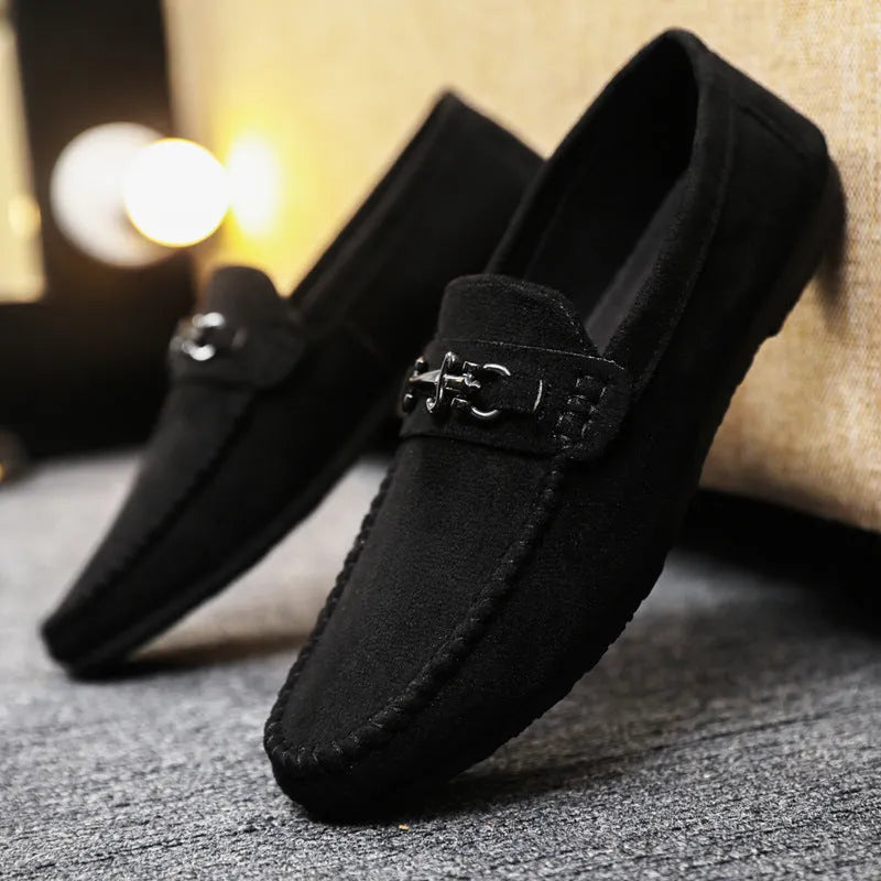 Men's black waterproof slip-on loafers with round toe and low heel on a rubber sole.