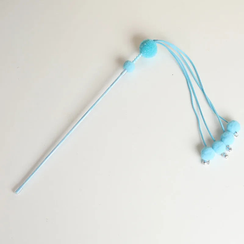 Set of four colourful cat stick toys with dangling tassels, showing blue, pink, and purple handles.