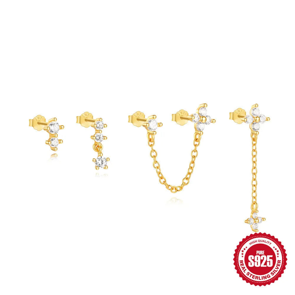 A pair of geometric clover petal earrings in sterling silver with an electroplated gold finish, shown against a neutral background.