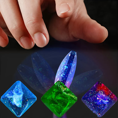 Galactic edition pocket gyro desk toy on a surface, showing its quadrilateral resin construction and celestial colour design.