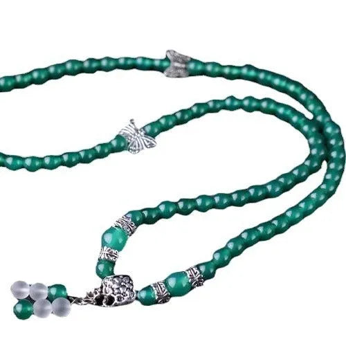 Close-up of a green agate multi-layer chain bracelet with three strands of 6mm beads.