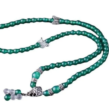 Close-up of a green agate multi-layer chain bracelet with three strands of 6mm beads.
