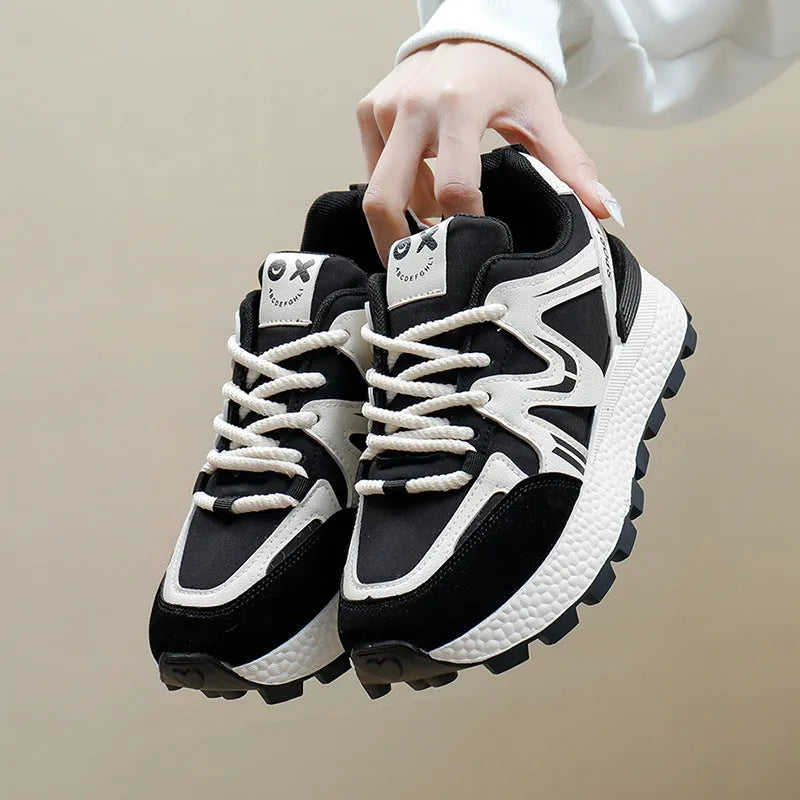 Women's black sports casual shoes with round toe and front lace-up design on a flat heel.