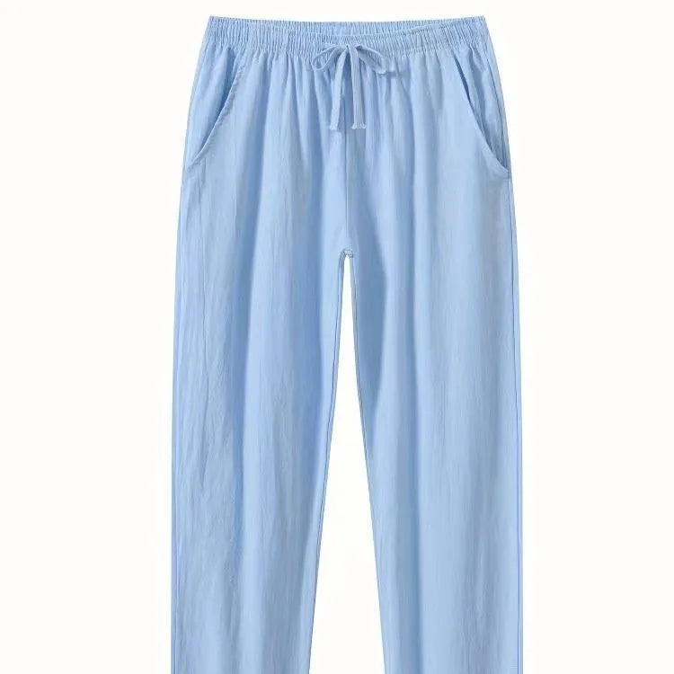 Man wearing loose-fitting cotton beach trousers in a solid colour, showcasing casual summer style.