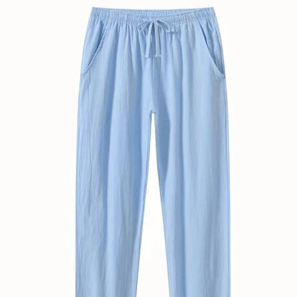 Man wearing loose-fitting cotton beach trousers in a solid colour, showcasing casual summer style.