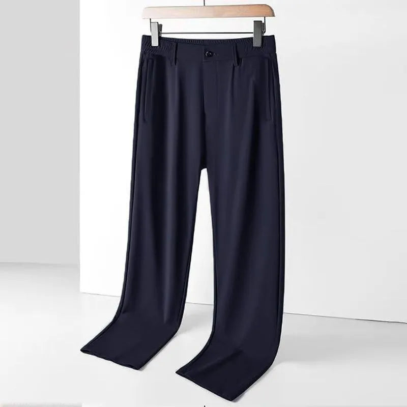 Man wearing black Ice Silk loose-fit casual trousers with an elastic waistband.