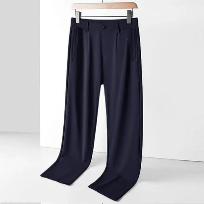 Man wearing black Ice Silk loose-fit casual trousers with an elastic waistband.
