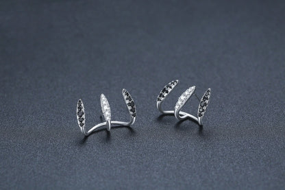 Elegant copper and zircon ear cuffs with a geometric design, showcasing British style and sophistication.