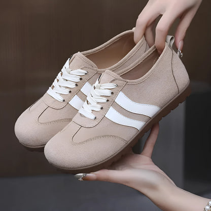Women's vintage canvas sneakers in dark red with a round toe and flat rubber sole.