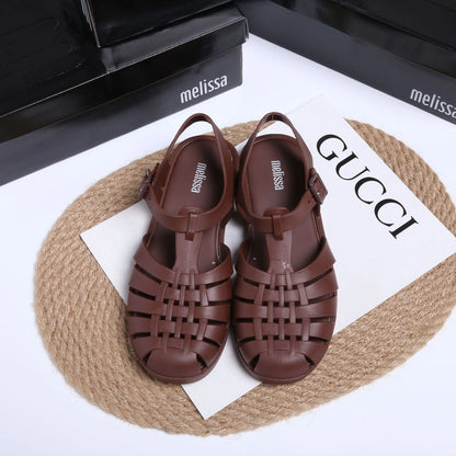 Matte black Roman sandals with vintage weave pattern, buckle fastening, and low-top PVC construction