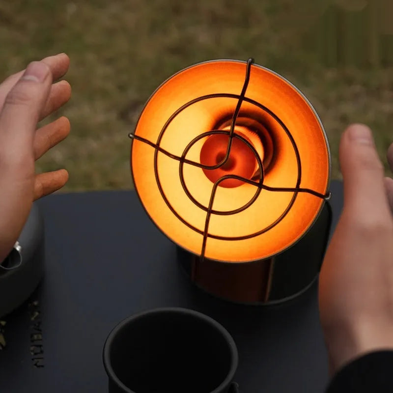 Black and orange portable heating stove with automatic ignition for camping, weighing 215g.