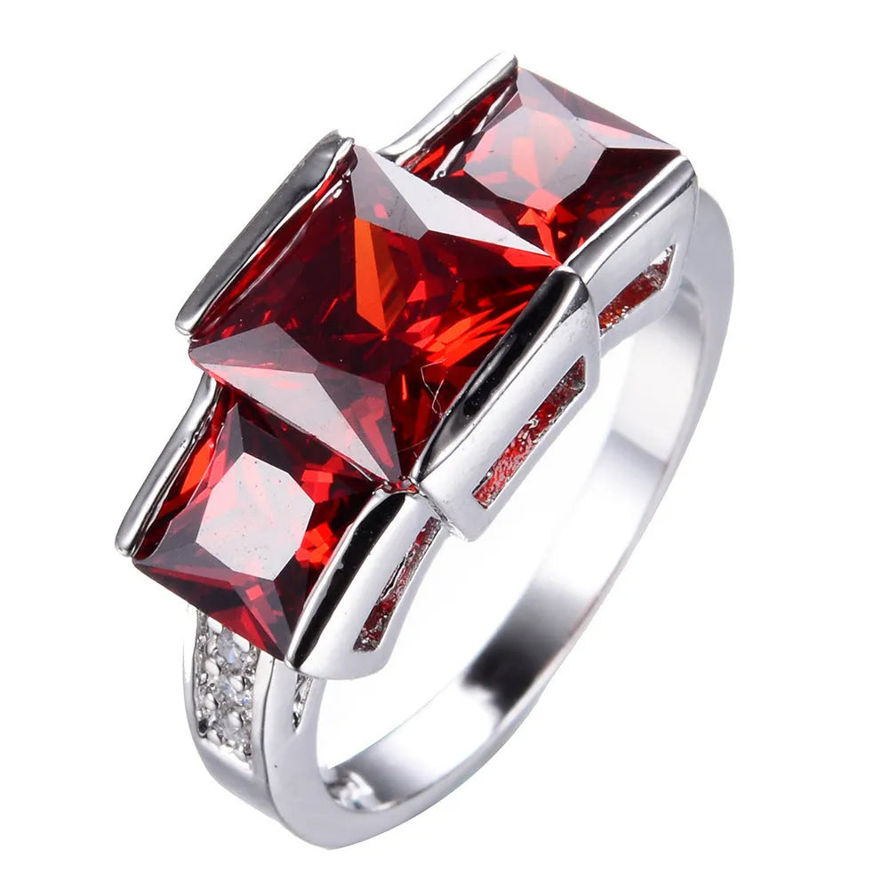 Aier Moxa geometric copper fashion ring in assorted electroplated colours on a plain background.