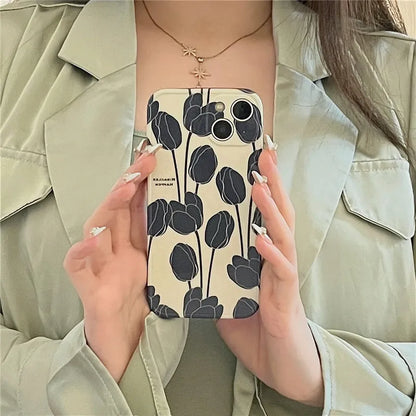 Black silicone iPhone case with a tulip floral pattern on the back.