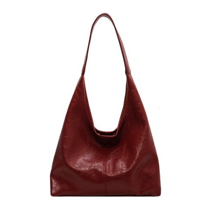 Classic vintage-inspired women's shoulder bag in a range of sophisticated colours, featuring a roomy interior, adjustable strap, and premium materials for timeless British style.