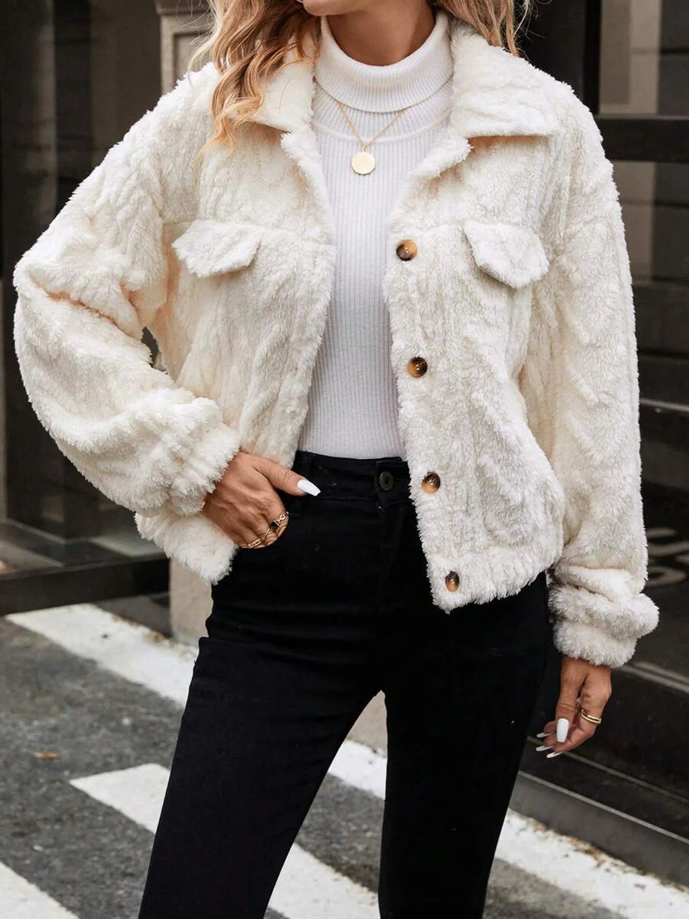 Ivory white women's button-front plush cardigan coat on a hanger