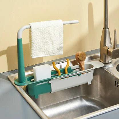 Telescopic plastic kitchen sink drain rack with multi-coloured modular baskets.