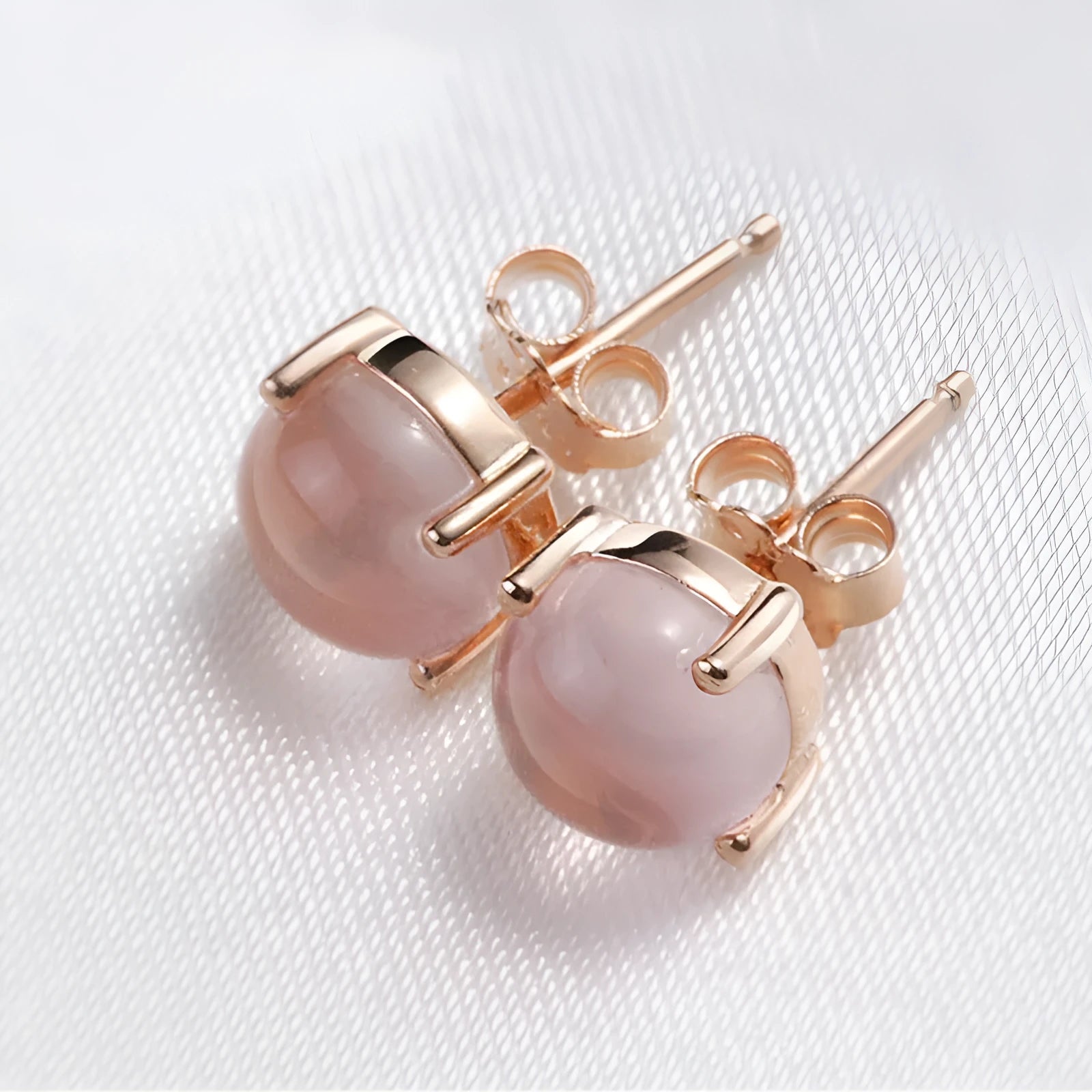 Women's simple Korean style drop shape stud earrings with synthetic ross quartz and rose gold finish.