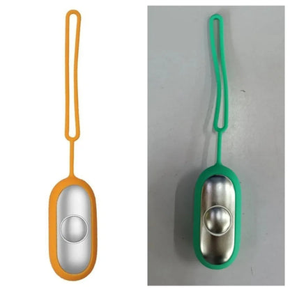 Hand-held micro-current sleep aid device in grey, green, or orange with round button and USB charging port